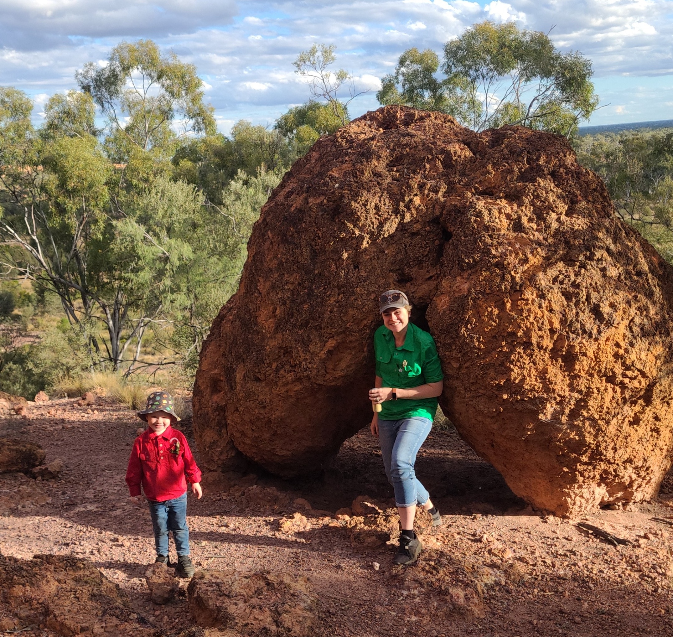 Photo of Monica and her child on a walk in the bush.